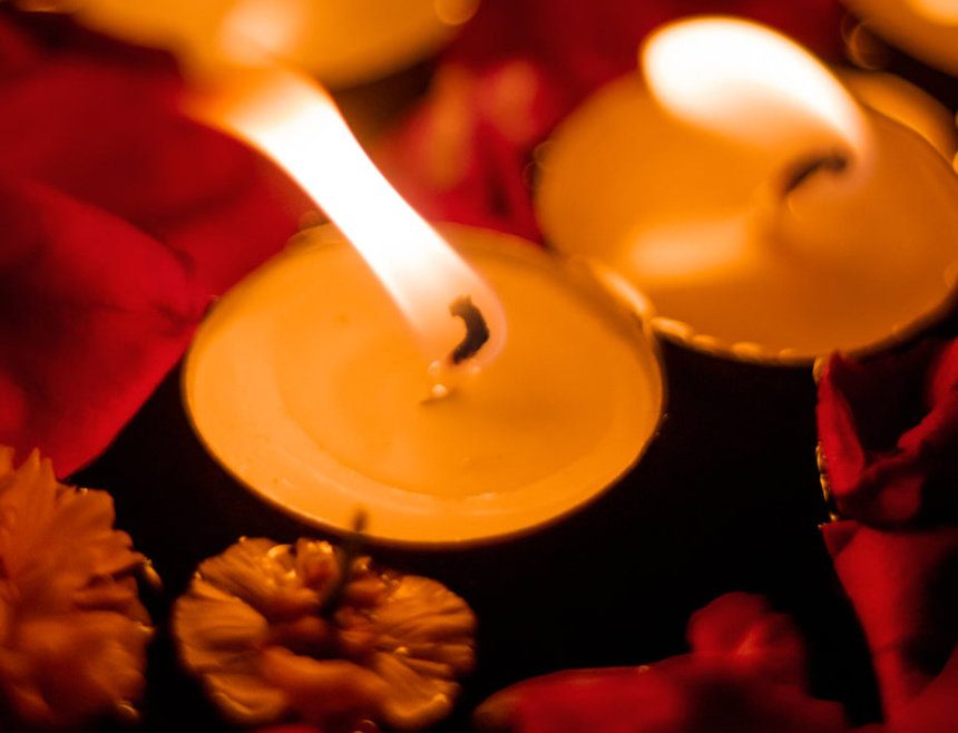 close-up-of-lit-white-tea-light-candles